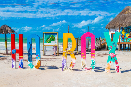 Iconic colorful letters at Holbox with turquoise waters and white sandy beach in the background.